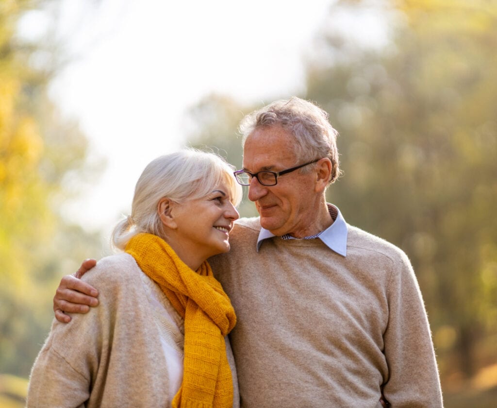 Happy senior couple in autumn park.