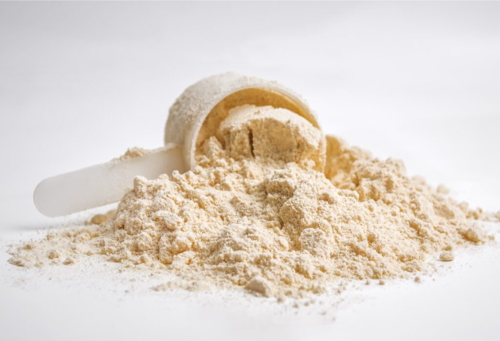 Powder protein with scoop isolated on white.