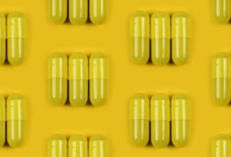 Pattern of yellow powder capsules on yellow background.