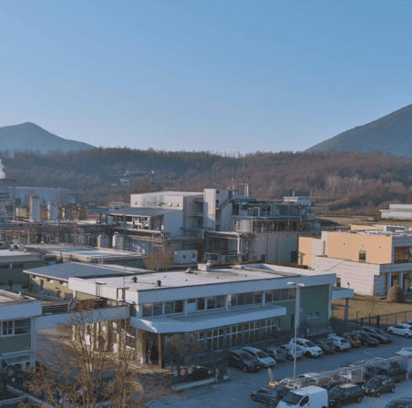 Wide exterior of manufacturing facility in the fall.