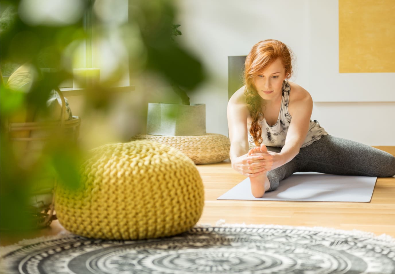 Active caucasian woman exercising on the floor at her home with yellow decor.